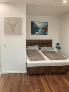 a bedroom with a bed and a painting on the wall at Ferienwohnung Paula Winterberg in Winterberg