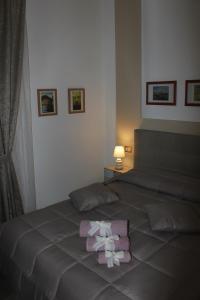 a bedroom with a bed with a pink bow on it at B&B 80056 Ercolano in Ercolano