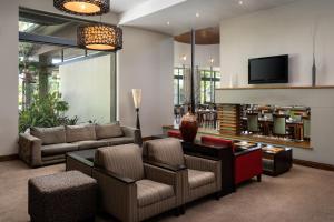 a living room with a couch and a tv at Premier Resort The Moorings, Knysna in Knysna