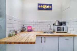 a kitchen with a wooden counter top with a microwave at Converted Luxury Stables in Haxby