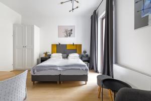 a bedroom with a bed and a table and chairs at Homewell Apartments Żelazko in Poznań