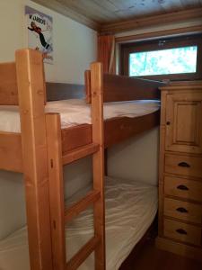 a bedroom with two bunk beds and a window at Megève - Appartement 2 chambres - Proche Centre et Pistes - Fibre - Parking in Megève +36 photos