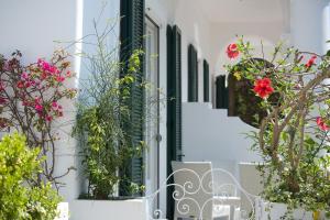 a white house with flowers on the windowsill at Villa Mariuccia Capri in Capri