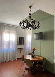 a dining room with a table and a chandelier at Al Ponte Del Papa B&B in Rome