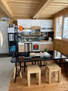 a kitchen with a black table and benches and a stove at Aparthotel Pr' Jakapč' in Mojstrana