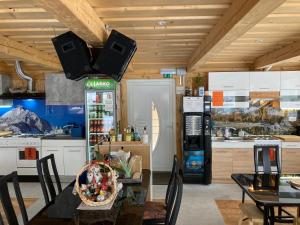 a kitchen with a table and a dining room at Aparthotel Pr' Jakapč' in Mojstrana +128 photos