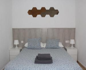 Ένα ή περισσότερα κρεβάτια σε δωμάτιο στο Estudio Malagueño Centro 1ºA
