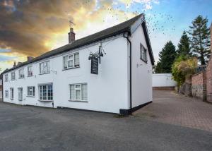 a large white building with a lot of windows at Donington Cottage Apt 4 in Castle Donington