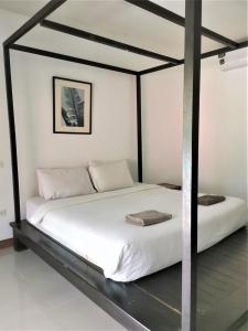 Postel nebo postele na pokoji v ubytování Natai House