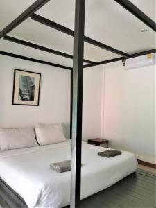 Postel nebo postele na pokoji v ubytování Natai House