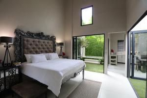 a bedroom with a large bed with a large window at Another World - Montagu in Montagu