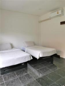 Postel nebo postele na pokoji v ubytování Natai House