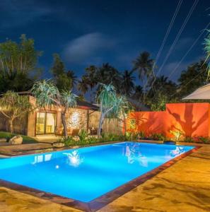 a swimming pool in front of a house at night at Natai House in Natai Beach