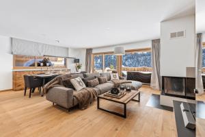 a living room with a couch and a table at Le Montagnier by Mrs Miggins in Champéry