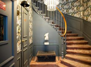 a staircase in a house with a chandelier at Hôtel Royal - Centre Comédie in Montpellier