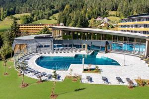 an aerial view of a building with a swimming pool at Vivea Hotel Bad Bleiberg in Bad Bleiberg