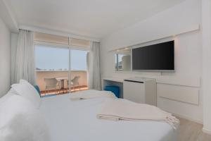a hotel room with a television and a bed at Iberostar Bouganville Playa in Adeje