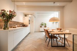 a kitchen and dining room with a table and chairs at Leidse Square 5 star Luxury Apartment in Amsterdam +31 photos