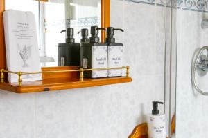 a bathroom with a shelf with toiletries on it at The Mayfield Apartments in Sunderland