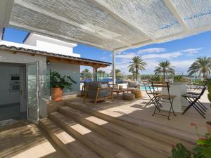 a patio with a pergola and a table and chairs at Pasitoblanco Porto Mare 45 Seaview Villa prívate heated pool in Pasito Blanco