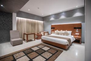 Postel nebo postele na pokoji v ubytování Hotel Niya Regency