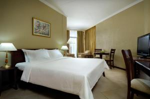 A bed or beds in a room at Berjaya Beau Vallon Bay Resort & Casino