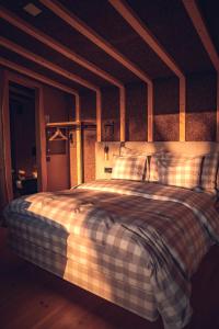 a bedroom with a bed with a checkered blanket at Charm Nature in Azoia