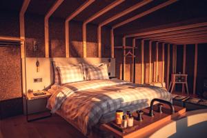 a bedroom with a bed with a striped comforter at Charm Nature in Azoia