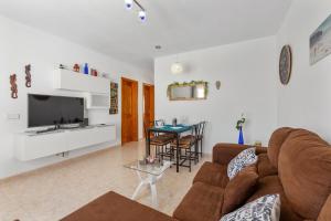 a living room with a couch and a table at Casa Donna in Playa Honda