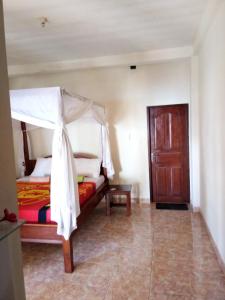 Ένα ή περισσότερα κρεβάτια σε δωμάτιο στο Sudi Homestay