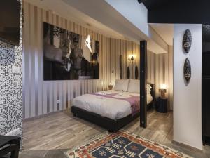 a bedroom with a bed and a painting on the wall at Snow Lodge Hotel Courchevel 1850 in Courchevel