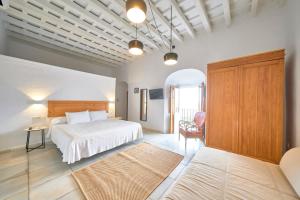 a bedroom with a bed and a table and a chair at Bekkeh Vejer in Vejer de la Frontera +70 photos
