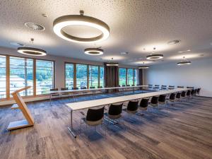 a large conference room with a long table and chairs at Vivea Hotel Bad Bleiberg in Bad Bleiberg +43 photos