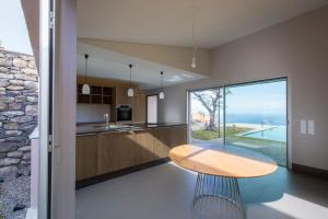 a kitchen with a table and a view of the ocean at Casa Atlantico Suite in Ribeira Brava