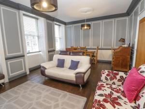 a living room with a couch and a chair at The Flat in Barnard Castle