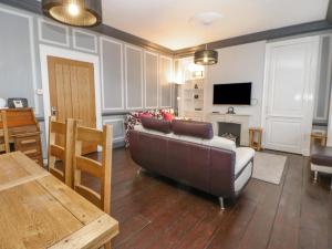 a living room with a couch and a table at The Flat in Barnard Castle