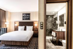 a hotel room with a bed and a bathroom at Hotel Grand City Wrocław in Wrocław