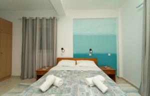 a bedroom with a bed with two pillows on it at Blue Houses Maisonettes in Kamária