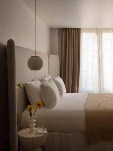 a bedroom with a white bed and a window at Nuage in Paris