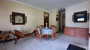 a dining room with a table and chairs and a mirror at Villa Denisa in Tlekung