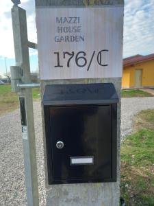 eine Mikrowelle auf einem Schild mit einem Hausgarten in der Unterkunft Mazzi House Garden in Dossobuono