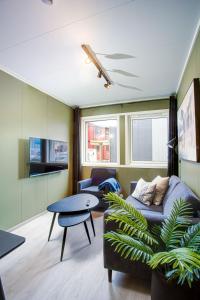 a living room with a couch and a table at Easy Home Apartments in Hammerfest +5 photos