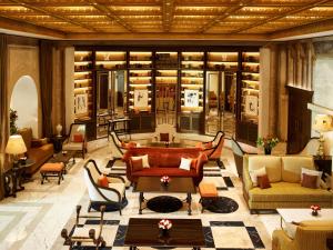 a large room with couches and chairs in a building at Hotel Eden - Dorchester Collection in Rome