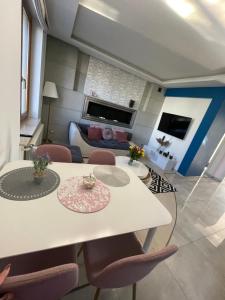 a living room with a white table and chairs at LUXURY BLUE APARTMENT by Marta in Radom
