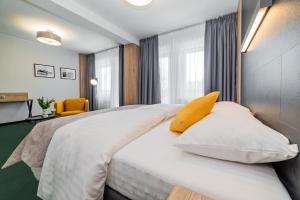 Posteľ alebo postele v izbe v ubytovaní Apartamenty PORTO