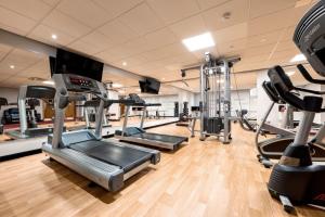 a gym with several treadmills and cardio machines at For Students Only Studio Apartments at Burges House in the heart of Coventry in Coventry