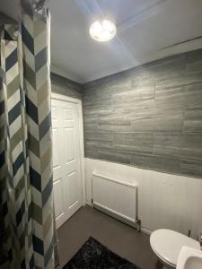 a room with a white door and a radiator at Cosy 3 Bedroom house, Free parking & WIFI in Nottingham
