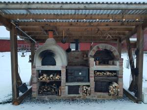 a brick oven with a roof on top of it at Stordrågen in Kil