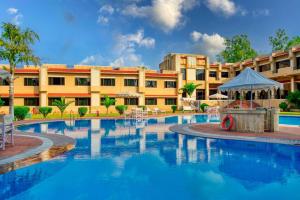 a hotel with a swimming pool in front of a building at Clarks Khajuraho in Khajurāho
