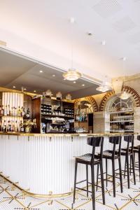 a bar in a restaurant with stools at Villa Mirasol in Mont-de-Marsan